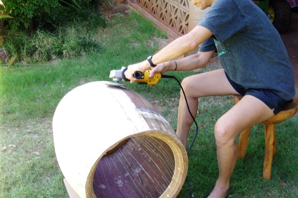 Judi Murakami of Taiko Kaua`i sanding the the drum body